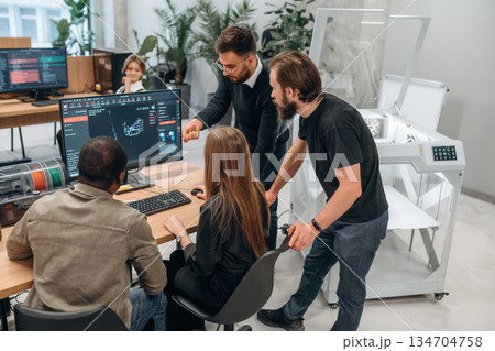 Working on a project together. Designer team are in the office Working on a project together. Designer team are in the office 134704758