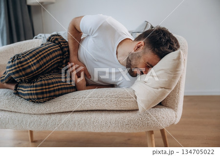 Abdominal pain. Sick man is feeling bad at home Abdominal pain. Sick man is feeling bad at home 134705022