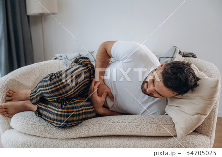 Pain in the stomach. Sick man is feeling bad at home Pain in the stomach. Sick man is feeling bad at home 134705025