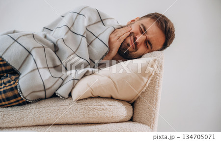 Feeling bad toothache. Sick man is feeling bad at home Feeling bad toothache. Sick man is feeling bad at home 134705071