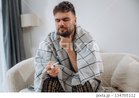 Using throat spray. Sick man is feeling bad at home Using throat spray. Sick man is feeling bad at home 134705112