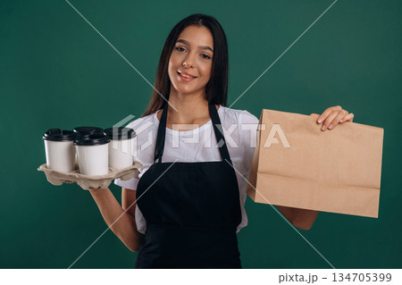 Your order is ready, with coffee. Young beautiful barista is against background 134705399