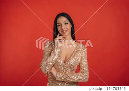 Looking forward, standing. Young elegant woman is against background 134705543