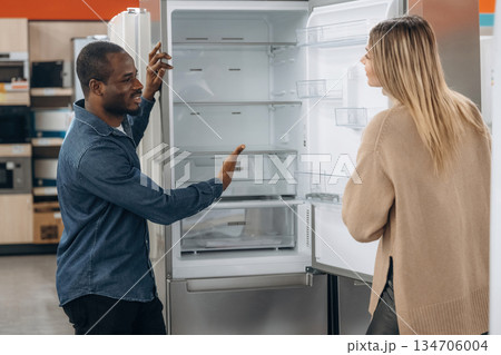 Man with woman are choosing fridge in the shop 134706004
