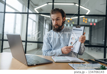 New plan, online conference. Businessman is working in the office New plan, online conference. Businessman is working in the office 134706143