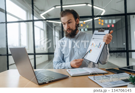 New plan, online conference. Businessman is working in the office New plan, online conference. Businessman is working in the office 134706145