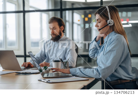 Working by laptops. Man and woman are in the office together 134706213
