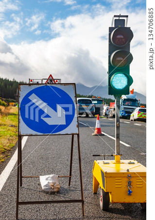 Temporary traffic lights and roadworks on rural highway Temporary traffic lights and roadworks on rural highway 134706885