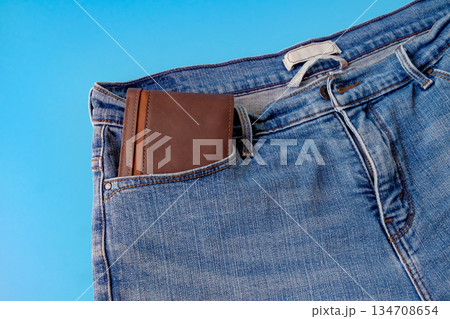 A brown pocket money in blue jeans pocket. Finances. A brown pocket money in blue jeans pocket. Finances. 134708654