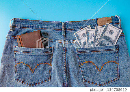 A brown pocket money in blue jeans pocket. Finances. A brown pocket money in blue jeans pocket. Finances. 134708659