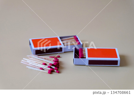 Pile of Wooden unused match stick in red box over the color background. 134708661