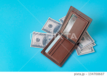 A brown leather wallet on color background. 134708687