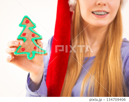 Woman holding christmas tree cookie 134709406