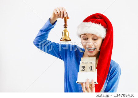 Woman and christmas calendar with bell Woman and christmas calendar with bell 134709410