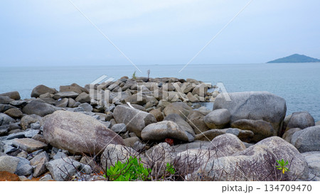 Coastal Rock Jetty with Granite Boulders and Calm Ocean View 134709470
