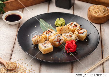 Tempura sushi rolls with sauce and sesame 134709487