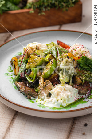 Warm beef salad with vegetables and egg Warm beef salad with vegetables and egg 134709494