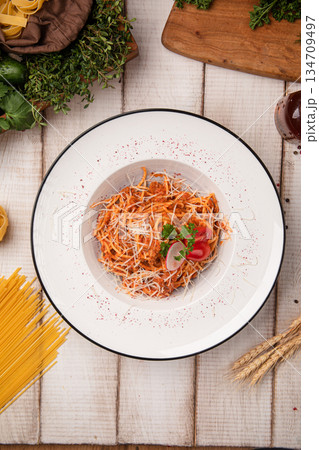 Spicy tomato pasta with grated cheese 134709497