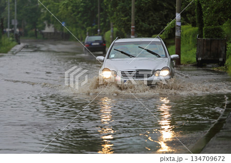 Car Driving Through Floods Car Driving Through Floods 134709672