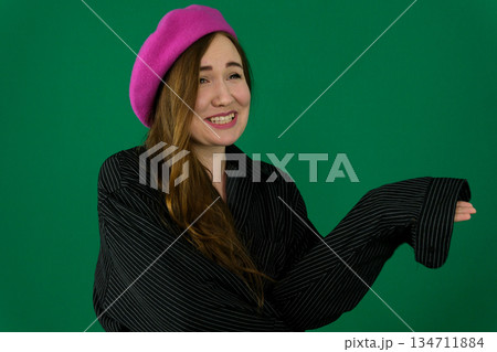woman on a green background chromakey in a black striped mens shirt different emotions facial expression close-up advertising space for text clean. kind eyes 134711884