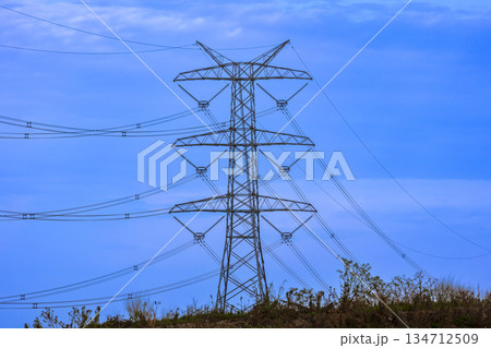 A large Transmission Tower set against a blue sky 134712509