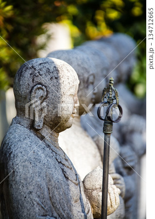 明るい日差しの下緑に囲まれて一列に並ぶ石のお地蔵様 東京都文京区の護国寺にて 明るい日差しの下緑に囲まれて一列に並ぶ石のお地蔵様 東京都文京区の護国寺にて 134712665