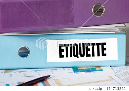 Blue File Folder Labeled Etiquette On Desk With Financial Documents And Pen Blue File Folder Labeled Etiquette On Desk With Financial Documents And Pen 134713222