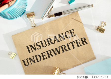 Cravt envelope with INSURANCE UNDERWRITER note on the office desk, concept. 134713223