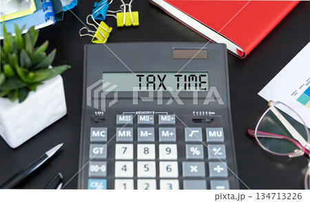 Tax Time word on calculator. Business and tax concept. Time to pay tax in year. Tax Time word on calculator. Business and tax concept. Time to pay tax in year. 134713226