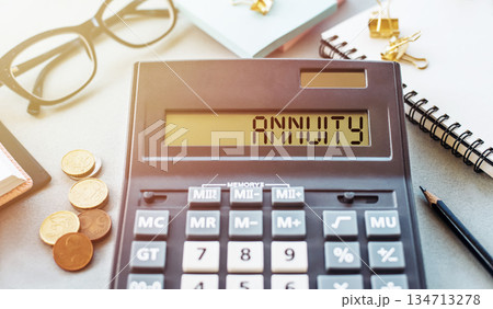 Calculator Displaying the Word Annuity on a Business Finance Desk 134713278