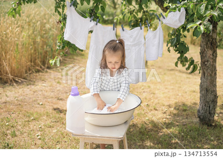 Hand washing of white linen and clothes. Bleaching and preserving whiteness with detergent and liquid detergents Hand washing of white linen and clothes. Bleaching and preserving whiteness with detergent and liquid detergents 134713554