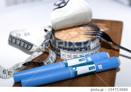 Weight loss concept featuring tuna fish and ozempic pen. Weight loss concept featuring tuna fish and ozempic pen. 134713980