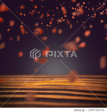 Wooden table surface with falling golden confetti and blurred background. Mockup or Copy space. Concept of festival or celebration 134719735