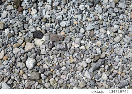 High angle shot of a large pile of small gravel stones in a variety of colors. Gravel is small and round. Gravel stone abstract texture background 134719743