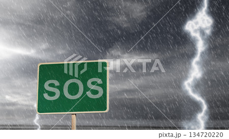 Green sign with the text "SOS" is prominently displayed against a backdrop of a dark and stormy sky featuring heavy rain and a vivid lightning strike Green sign with the text "SOS" is prominently displayed against a backdrop of a dark and stormy sky featuring heavy rain and a vivid lightning strike 134720220
