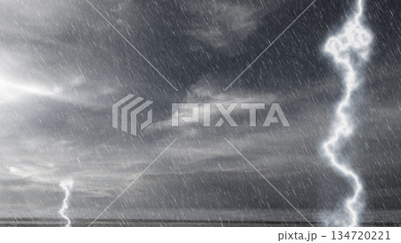 Dramatic scene featuring a dark and stormy sky filled with heavy rain and bright lightning strikes 134720221