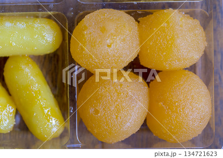 fresh Gold Egg Yolks Drops and Bean Paste in plastic containers packaging 134721623