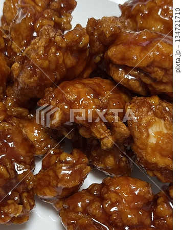 Crispy Korean fried chicken, perfectly glazed with a sweet and spicy sauce. Ideal for food photography and menus, showcasing the irresistible crunch and flavor of this beloved dish. 134721710