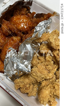 Crispy Korean fried chicken, perfectly glazed with a sweet and spicy sauce. Ideal for food photography and menus, showcasing the irresistible crunch and flavor of this beloved dish. 134721714