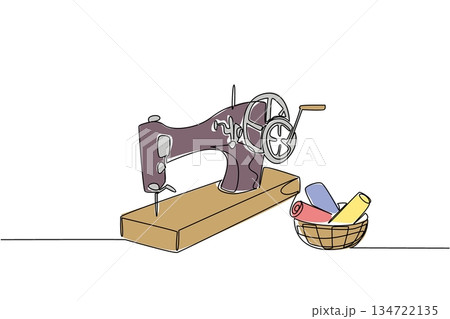Continuous line draw of vintage sewing machine next to basket filled with rolls of colorful fabric. Symbolize the timeless connection between sewing tools and materials.  National Sewing Machine Day 134722135