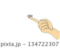 Continuous line drawing of hand holding small round button battery balanced on the tip of index finger, symbolizing the small size and easy access of hazard. National Button Battery Awareness Day 134722307