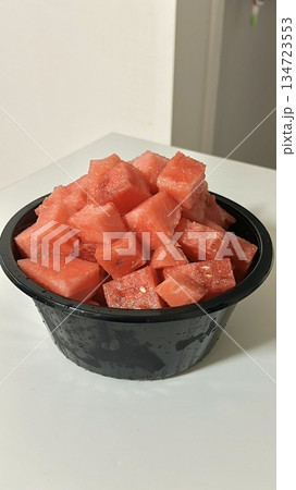 Fresh red watermelon cubes, juicy and refreshing, perfect for a sweet, hydrating snack or as a colorful addition to salads and fruit bowls. A summer favorite that offers natural sweetness. 134723553