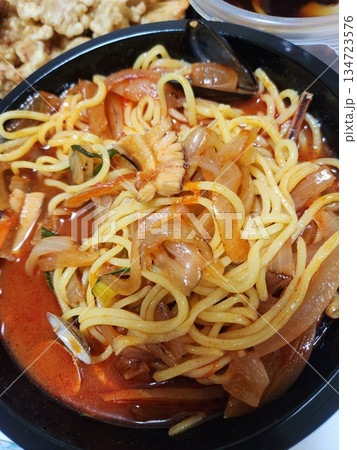 A steaming bowl of jjampong, the spicy Korean-Chinese noodle soup loaded with seafood, vegetables, and rich, flavorful broth. A hearty and satisfying comfort dish. A steaming bowl of jjampong, the spicy Korean-Chinese noodle soup loaded with seafood, vegetables, and rich, flavorful broth. A hearty and satisfying comfort dish. 134723576