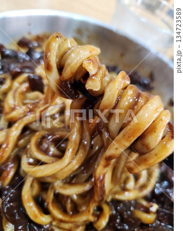 Classic jajangmyeon with thick noodles in a rich black bean sauce, garnished with sliced cucumber and sesame seeds. A beloved Korean-Chinese comfort dish, full of savory depth and flavor. Classic jajangmyeon with thick noodles in a rich black bean sauce, garnished with sliced cucumber and sesame seeds. A beloved Korean-Chinese comfort dish, full of savory depth and flavor. 134723589