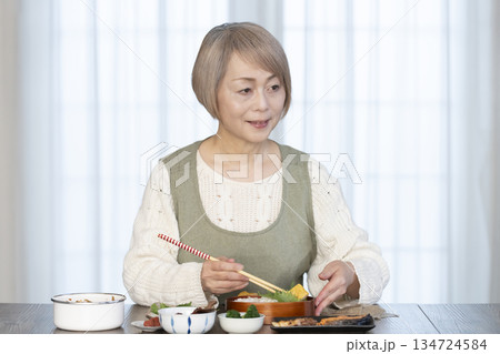 キッチンで弁当を作るシニア女性 134724584