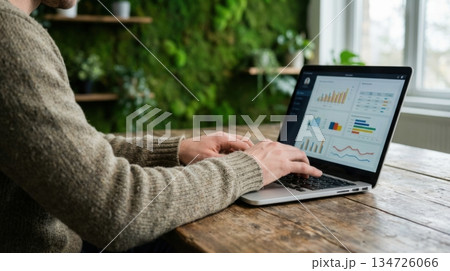 Person Working on Laptop in Eco Friendly Office with Green Moss Wall Person Working on Laptop in Eco Friendly Office with Green Moss Wall 134726066