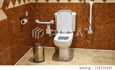 Accessible restroom with grab bars on the wall Accessible restroom with grab bars on the wall 134726393