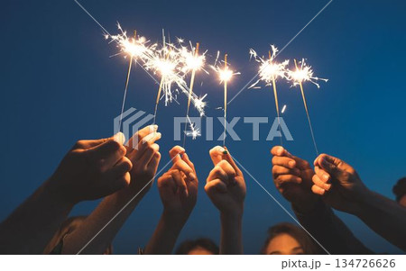 people holding sparkler on the background of the night people holding sparkler on the background of the night 134726626