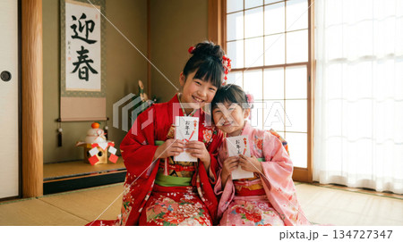お正月にお年玉をもらい喜ぶ晴着を着た子どもたち 134727347