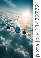 Modern Jetliner Soaring Above Clouds with Sunlit Wings at High Altitude 134727721